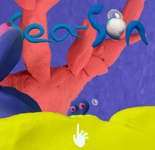 SeaSon title screen: clay coral, clay lettering, and a small sea creature peeking over a yellow clay sea floor